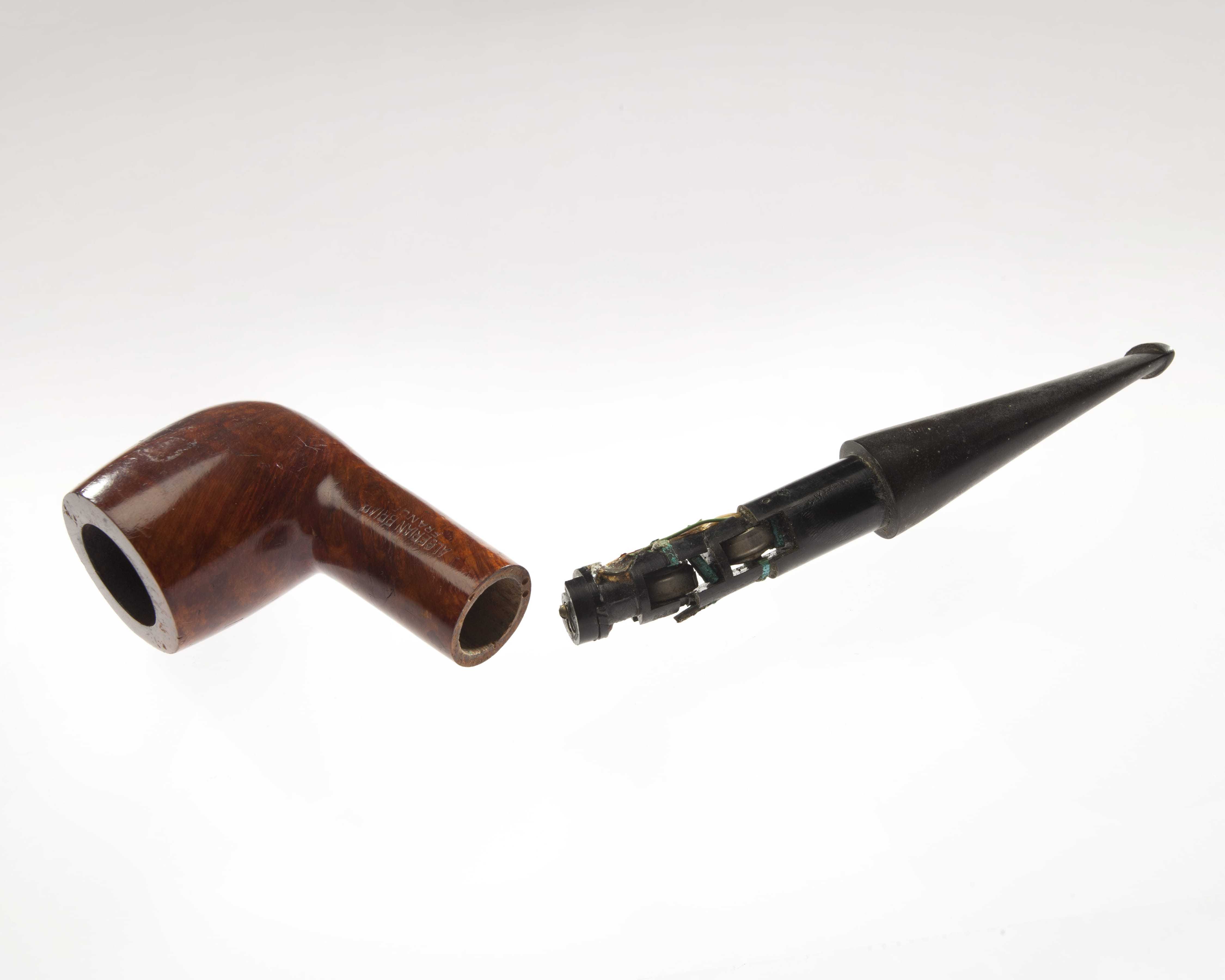 A pipe separated in the middle to reveal a small radio receiver concealed inside