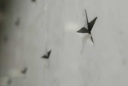 A close up of an engraved star on the memorial wall.