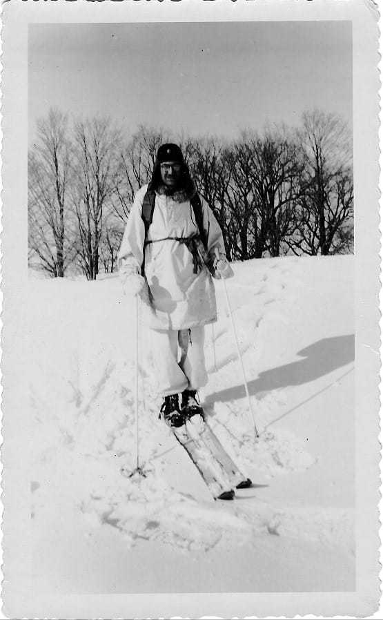 William Colby on a snowy hill with skis on.