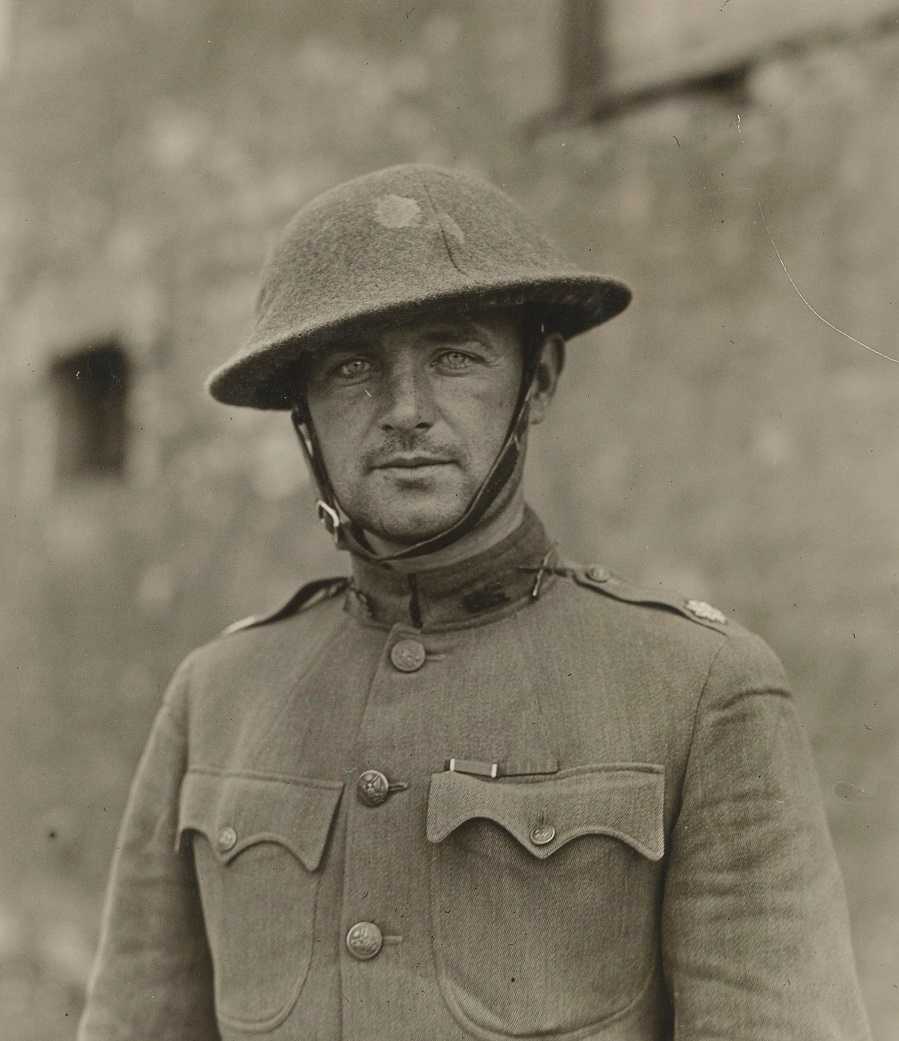 old photograph of young William Donovan in military suit and hard helmet looking into camera.