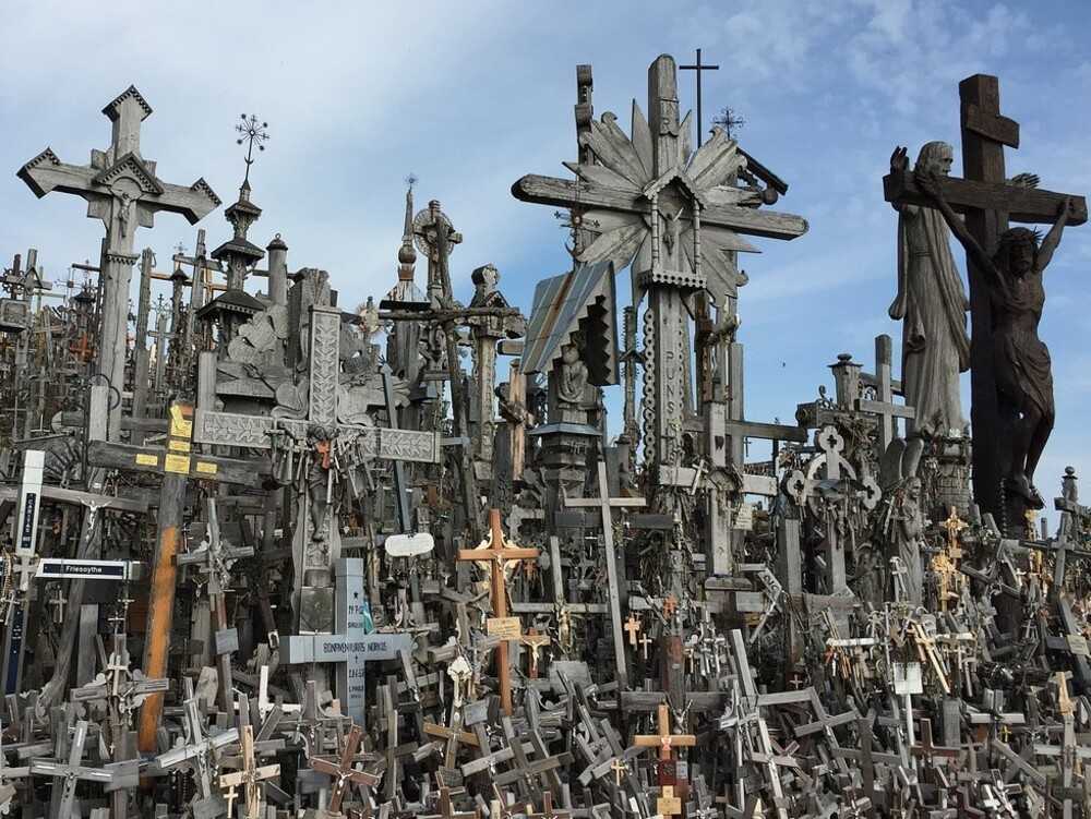 Lithuania’s Hill of Crosses is located 12 km (7.4 mi) north of the city of Šiauliai, in northern Lithuania. The tradition of leaving crosses on the hill is believed to have started after the 1831 uprising at a fort on the site, when citizens erected crosses to honor the rebels whose bodies could not be found.  With an estimated 100,000 crosses -- as well as statues of the Virgin Mary, tiny effigies, and rosaries -- the Hill of Crosses symbolizes the peaceful endurance of the Lithuanian people despite the threats they faced throughout history. During the Soviet occupation (1944-1990), the hill signified the public’s opposition to the ruling country and its religious suppression.  Today it is a Catholic pilgrimage site, and UNESCO recognizes cross-making as part of the cultural heritage of Lithuania.