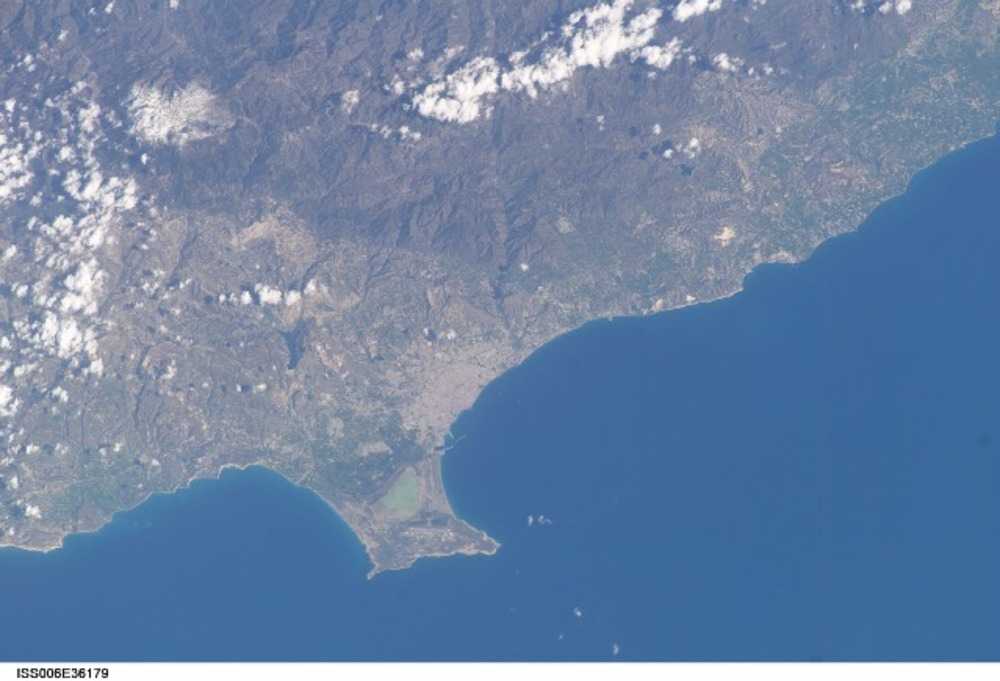 The Sovereign Base Area of Akrotiri juts into the Mediterranean Sea in this astronaut photo from 2003. The salt lake appears green in this image; the gray area further north is the Cypriot city of Limassol. Image courtesy of NASA.