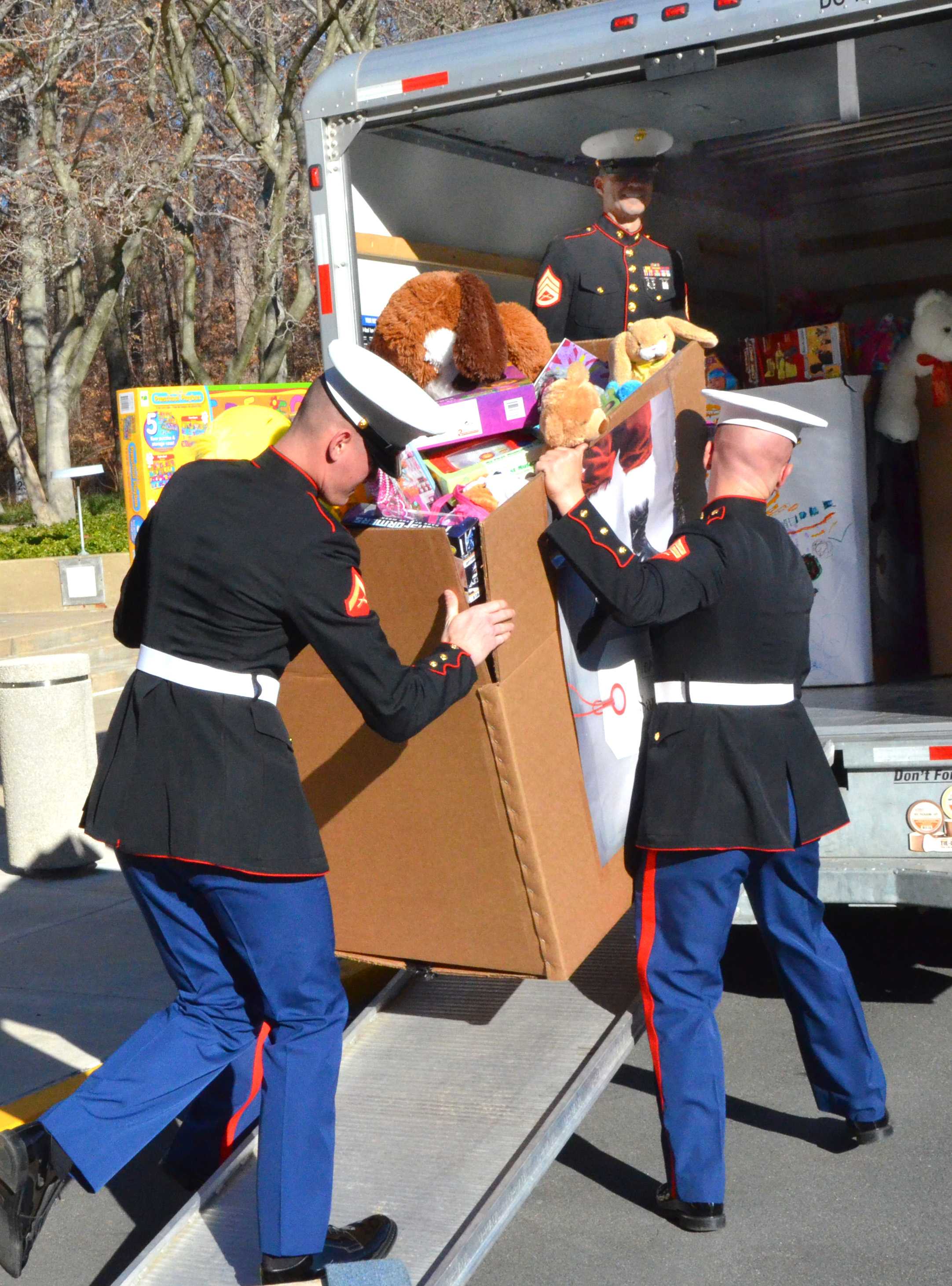 Photo of Marines from Quantico Base “Toys for Tots” program load donations onto a truck.