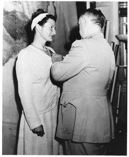 Virginia Hall being awarded the Distinguished Service Cross by an official.
