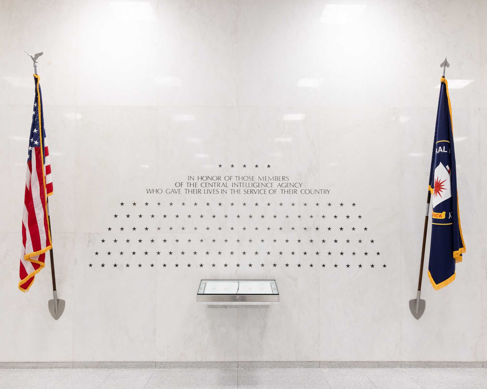 The American flag and the CIA flag on either side of an inscription with 140 stars engraved.