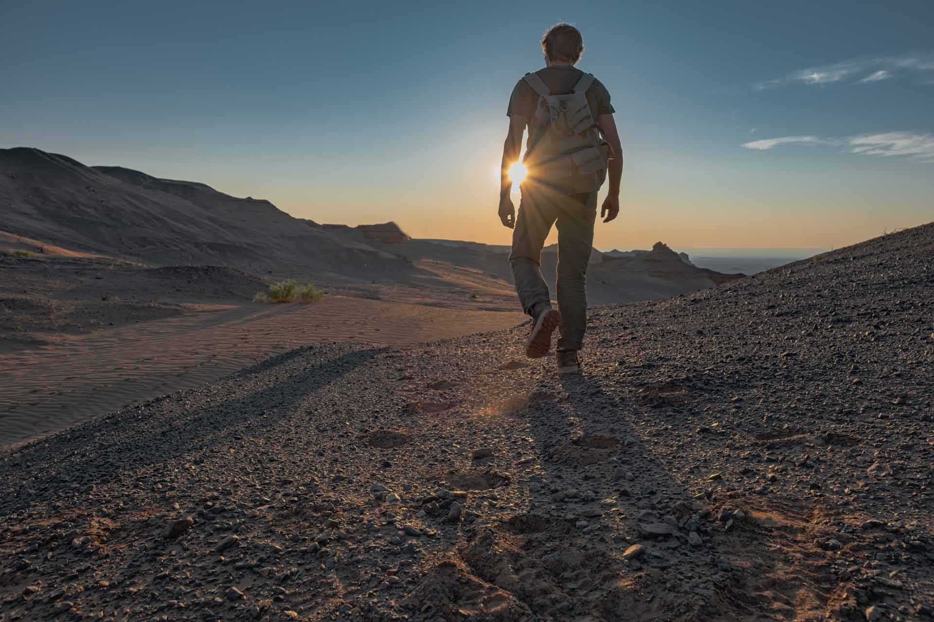 A man walking in the desert.