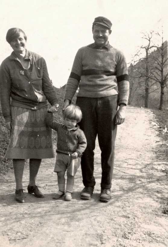 Ernest Hemingway and his wife, Hadley Richards, walking hand-in-hand with their son, Jack.