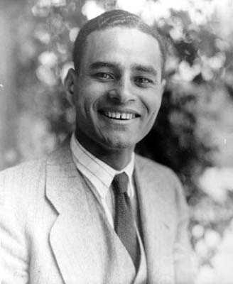 black and white photo of a young man, smiling at the camera