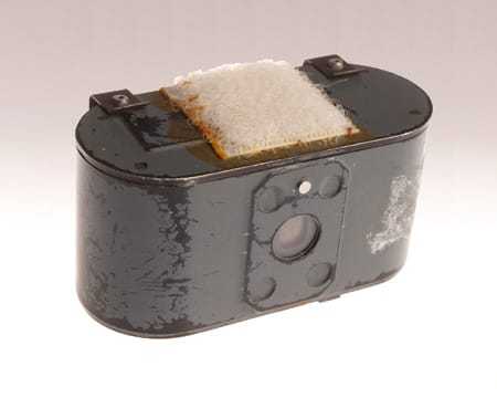 A close view of the camera used on the pigeon, with a piece of Velcro to attach it to the bird's harness