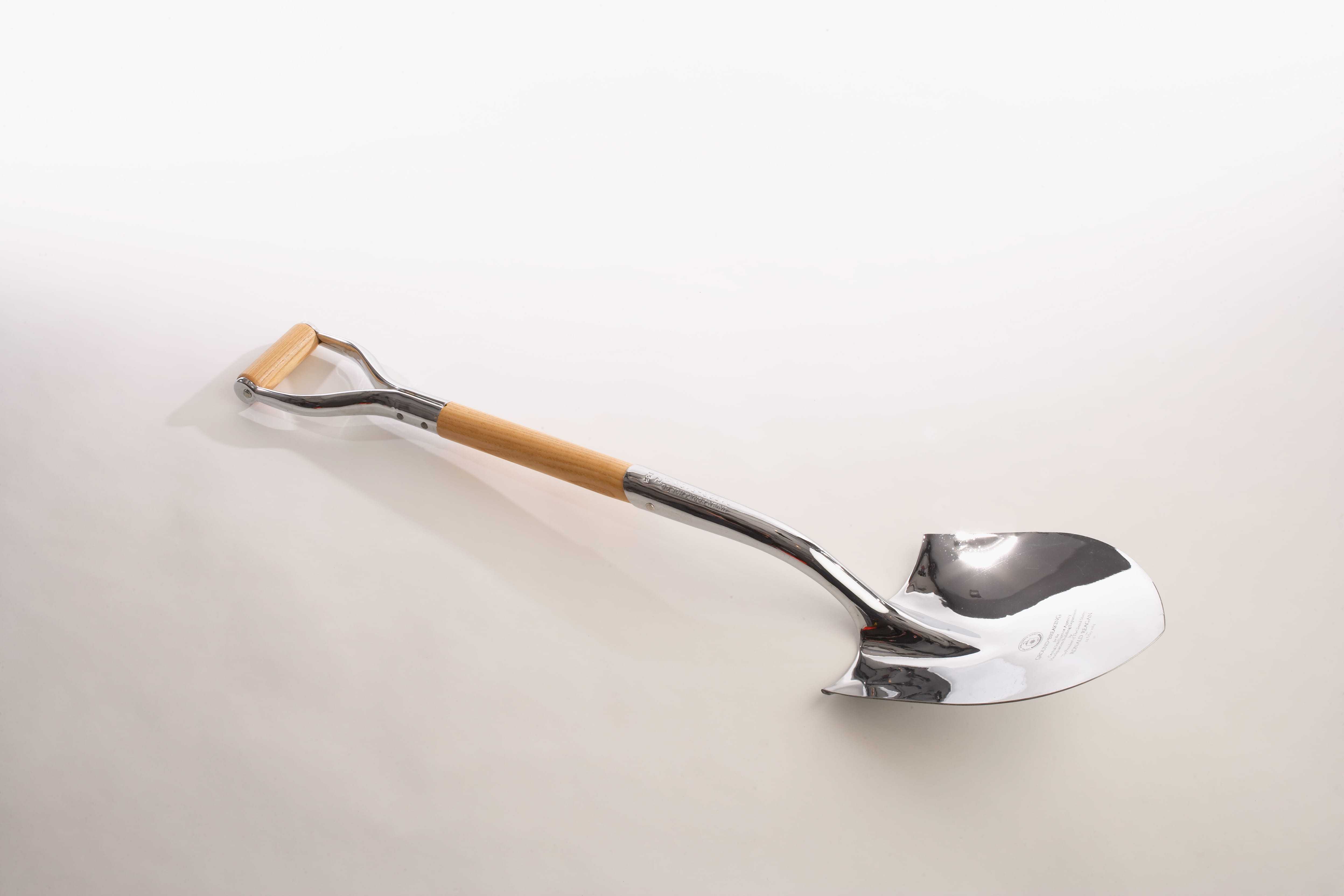 A shovel with an inscription memorializing the groundbreaking of the CIA's new headquarters