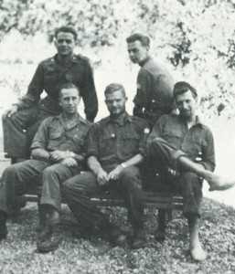 Jack, in the middle, with his OSS team on an outdoor bench.