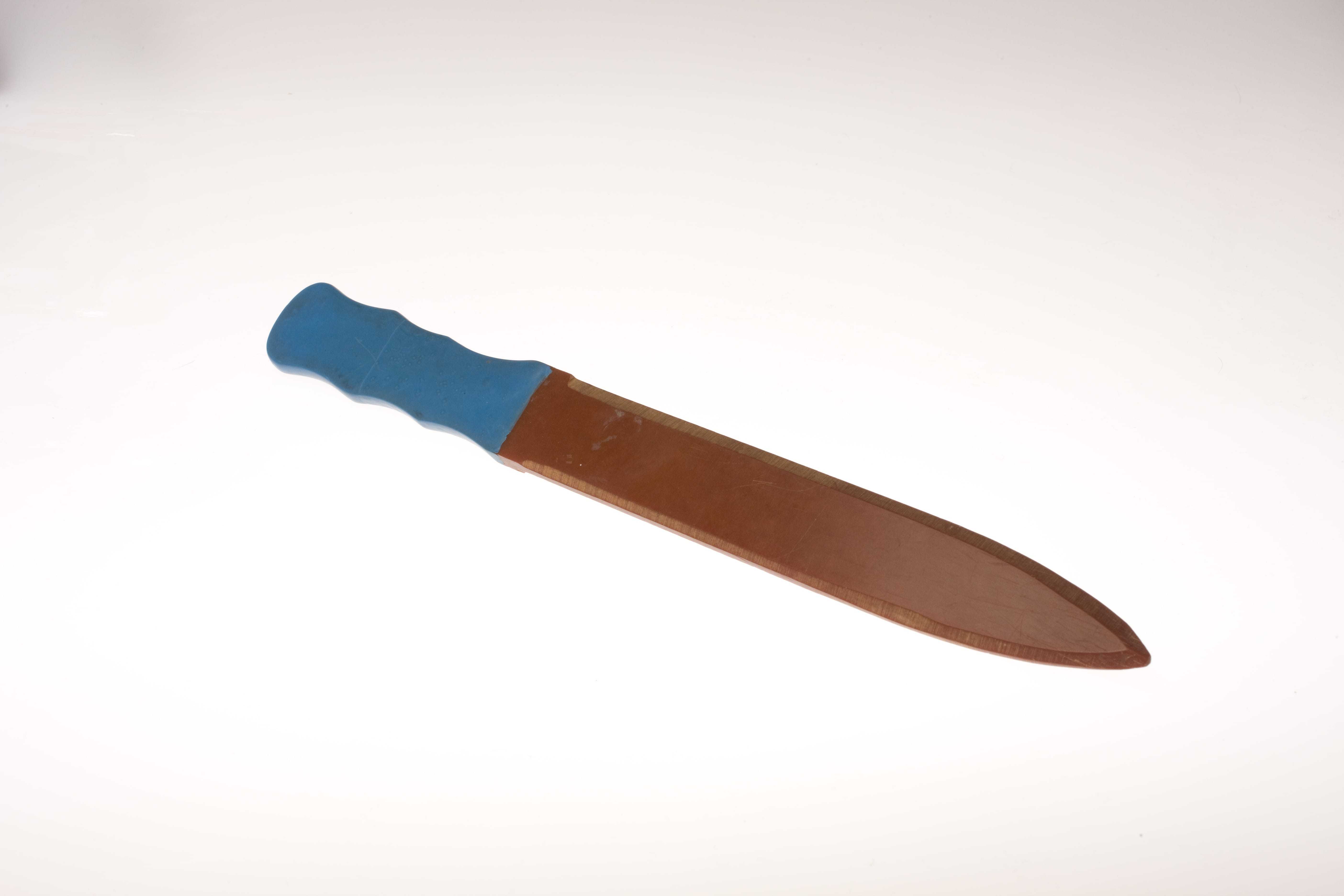 A brown colored mine probing tool with a blue handle
