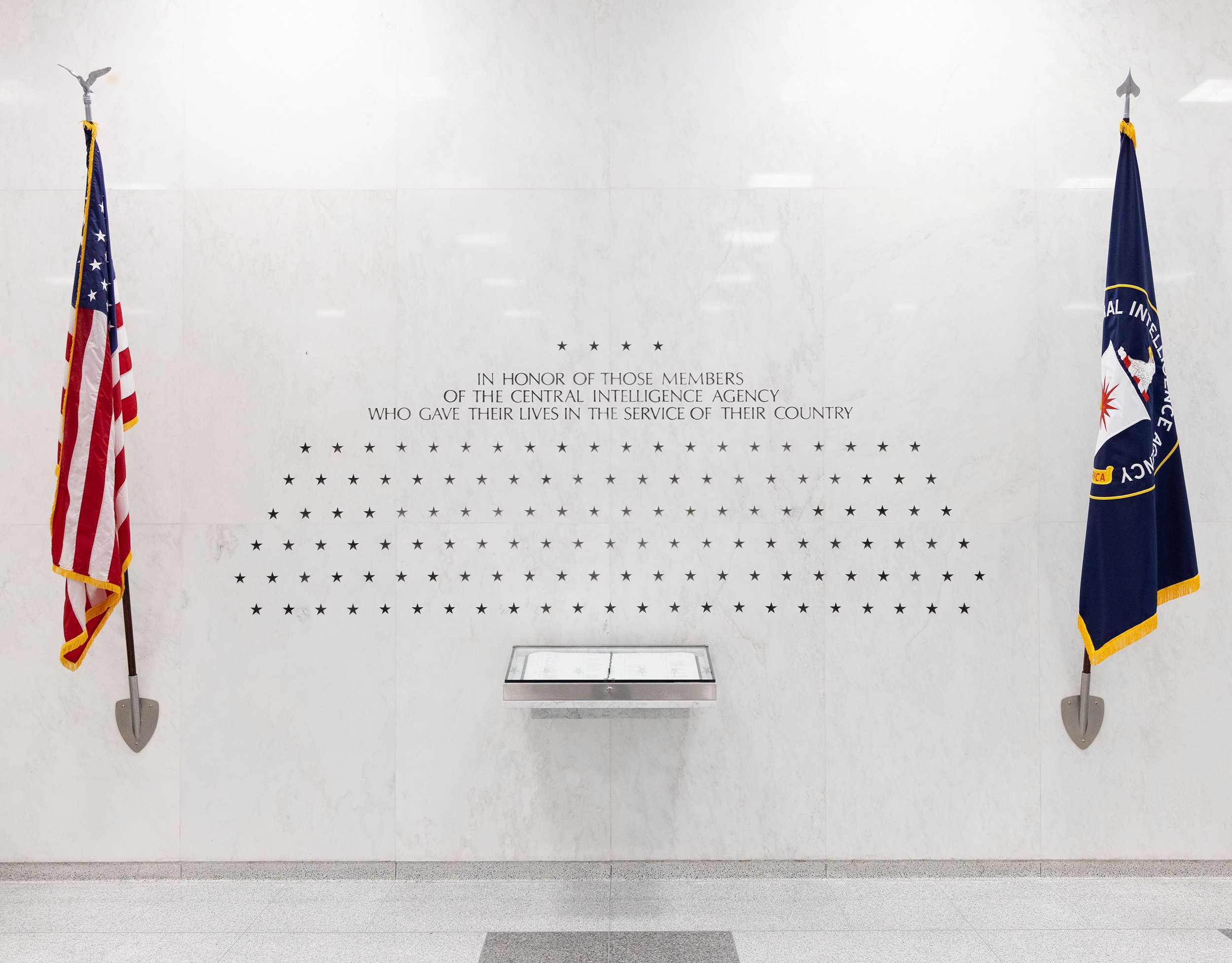 The American flag and the CIA flag on either side of an inscription with 137 stars engraved.