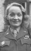 A black and white headshot of Marlene dressed in uniform and smiling with a closed mouth.