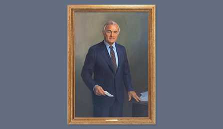 A portrait of former CIA director Admiral Stansfield Turner in a gold frame.