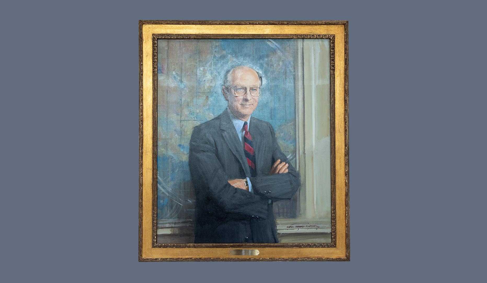 A portrait of former CIA director R. James Woolsey in a gold frame.