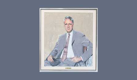 A portrait of former CIA director James R. Schlesinger in a gold frame.