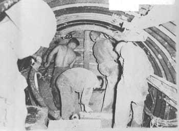 Five men excavating the Berlin Tunnel.