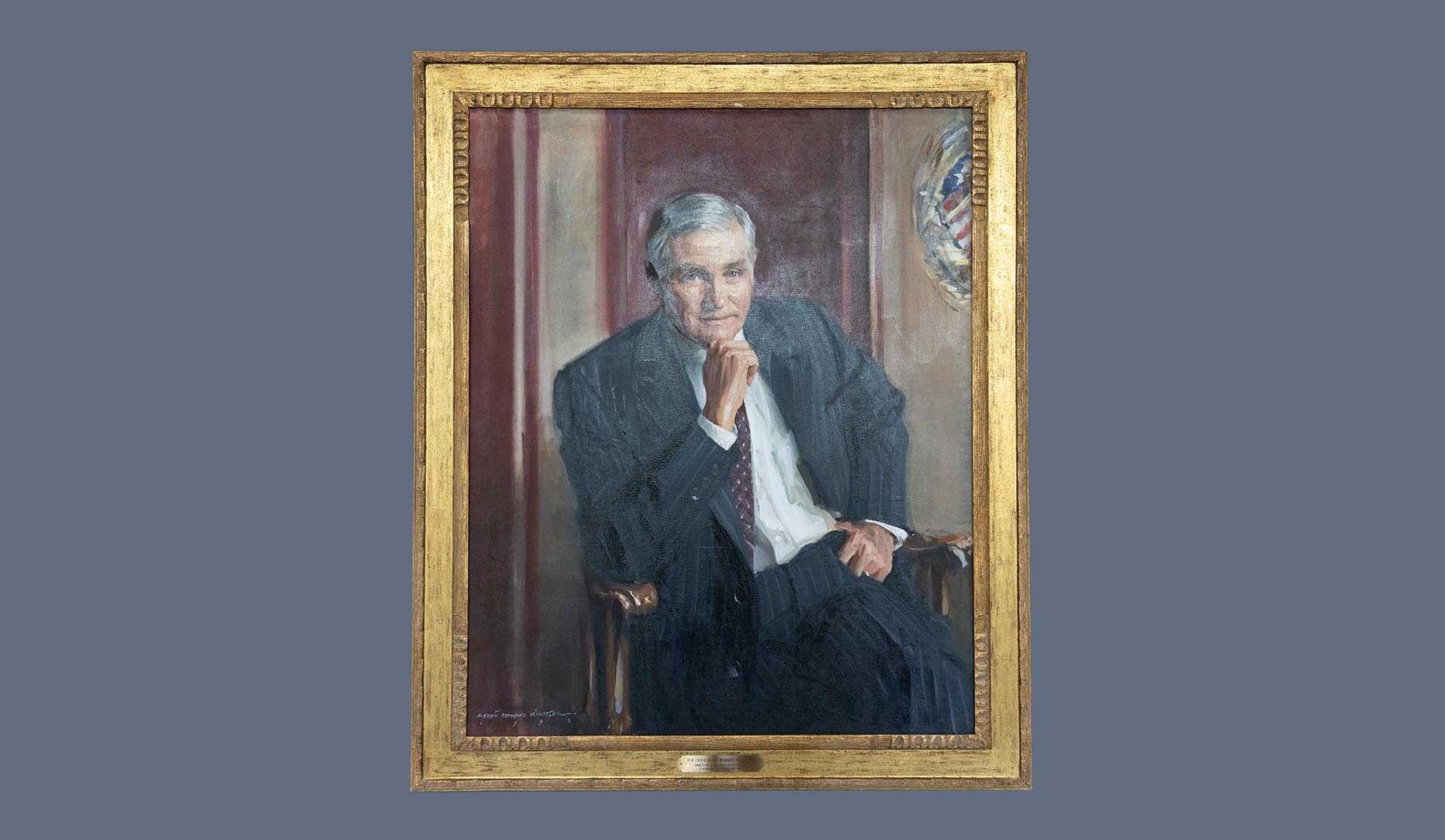 A portrait of former CIA director Robert M. Gates in a gold frame.
