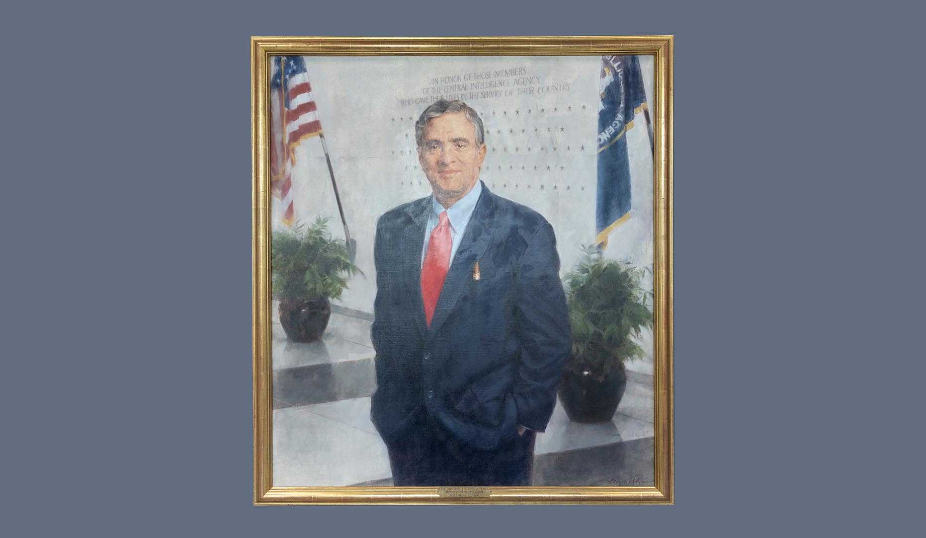 A portrait of former CIA director George J. Tenet in a gold frame.
