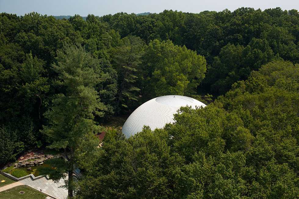 An aerial view of the CIA Headquarters Auditorium, surrounded by trees.