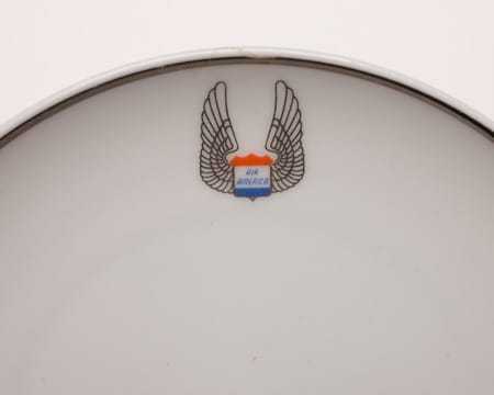 A close view of the Air America logo on the dinner plate
