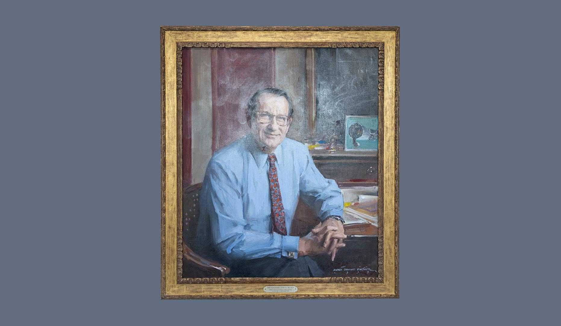 A portrait of former CIA director John M. Deutch in a gold frame.