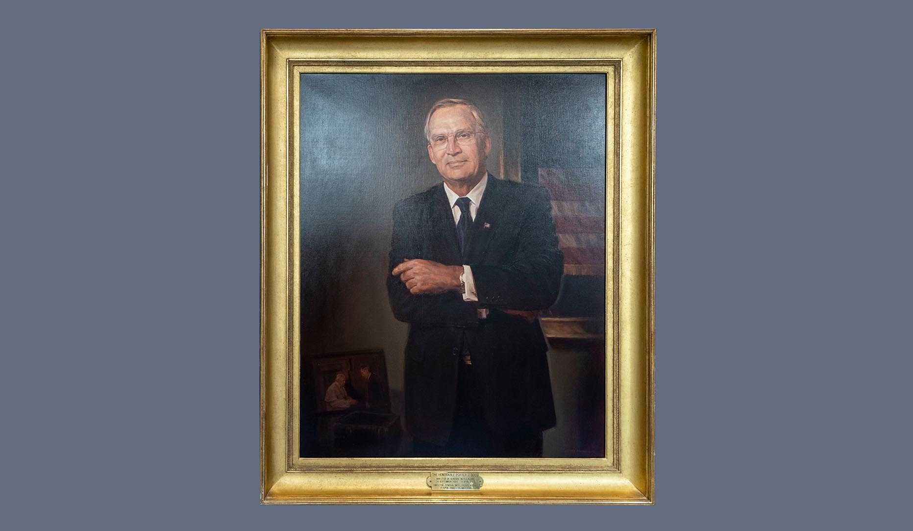 A portrait of former CIA director Porter J. Goss in a gold frame.