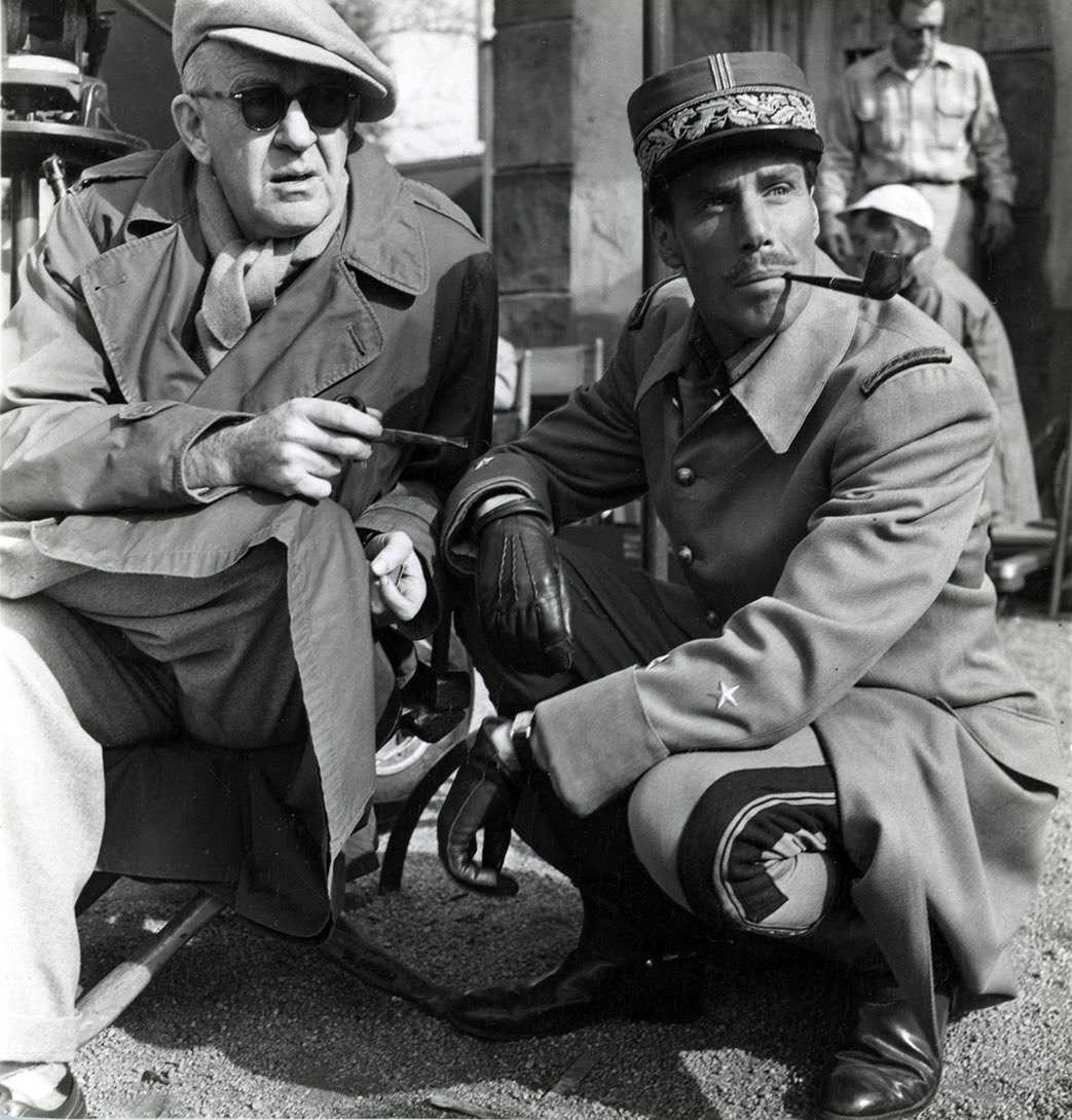 black and white photo of two men kneeling.