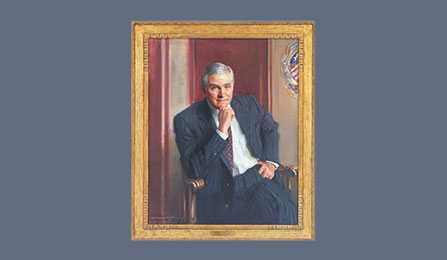 A portrait of former CIA director Robert M. Gates in a gold frame.