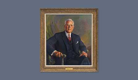 A portrait of former CIA director John A. McCone in a gold frame.