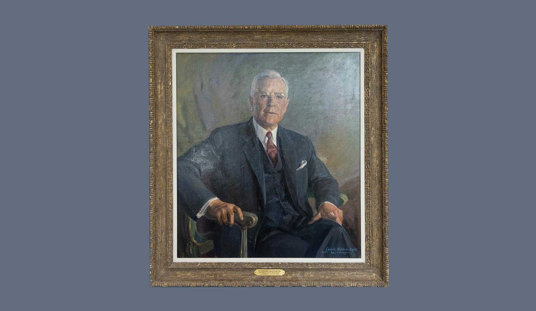 A portrait of former CIA director John A. McCone in a gold frame.