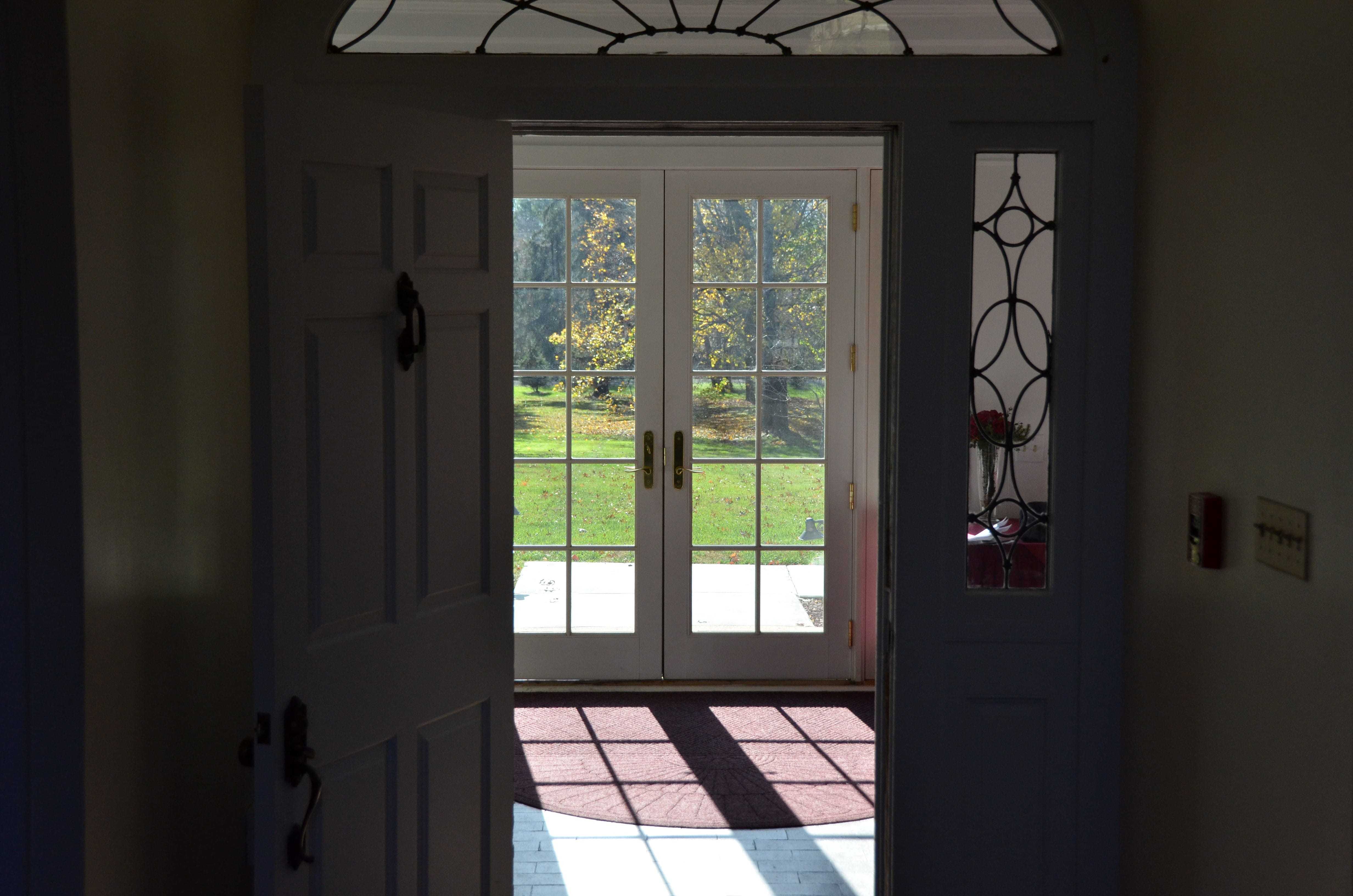 An inside perspective of the entryway of the manor and the pair of french doors.