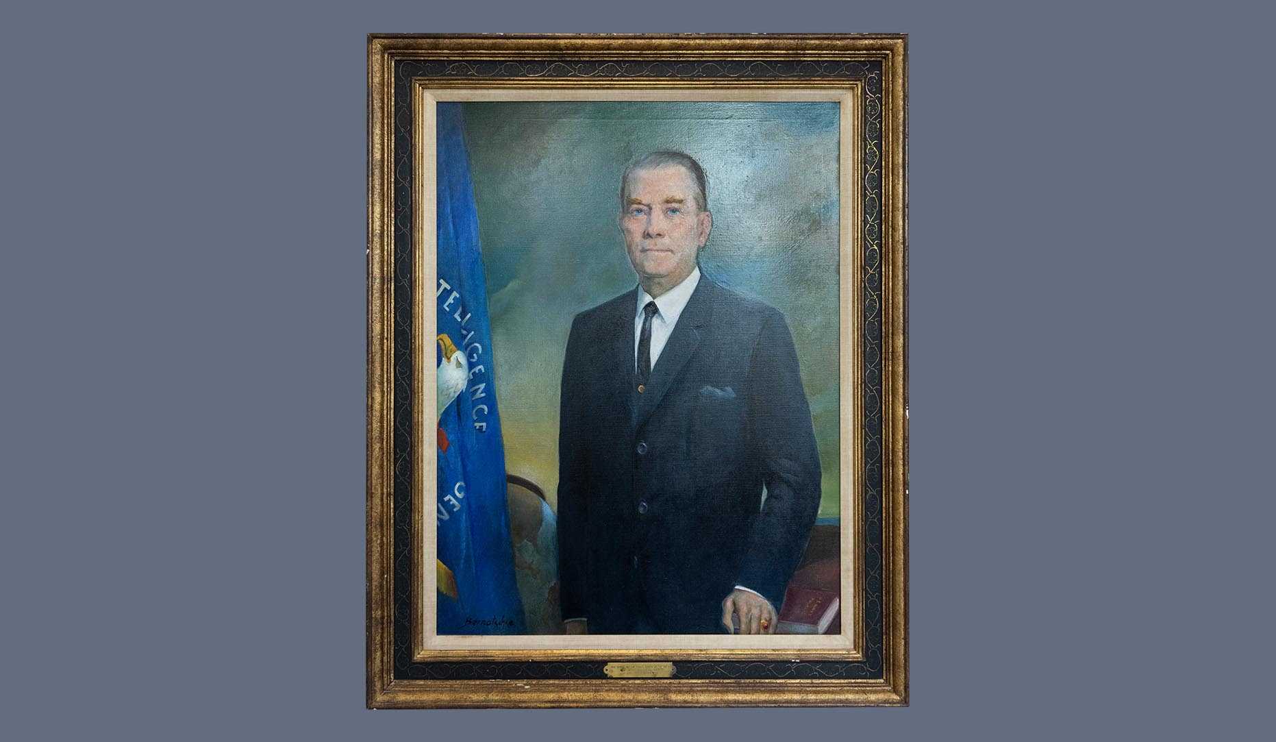 A portrait of former CIA director William F. Raborn, Jr. in a gold frame.