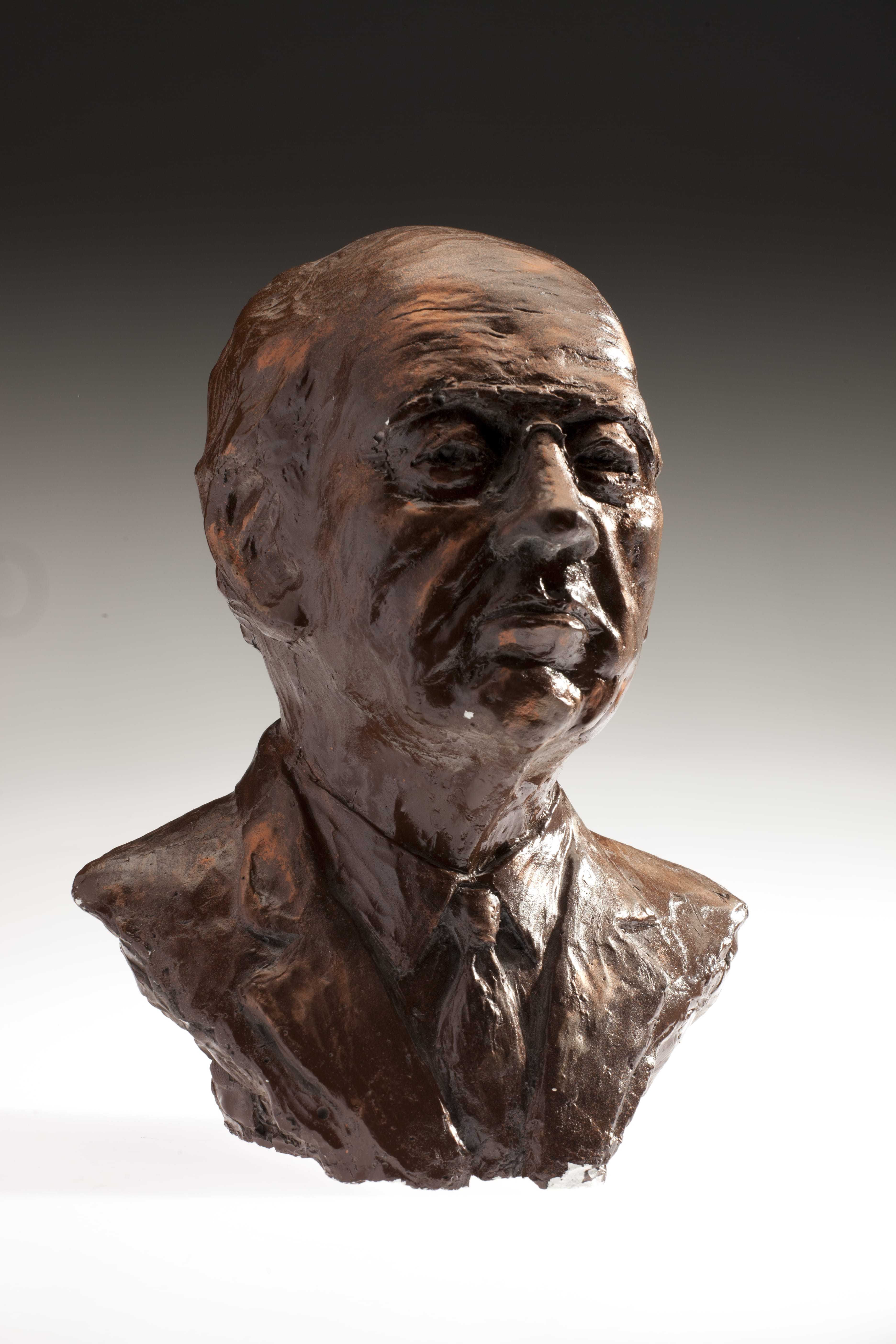 A brown bust of William J Casey.