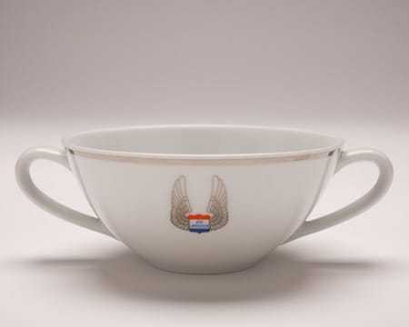 A teacup with two handles and the Air America logo