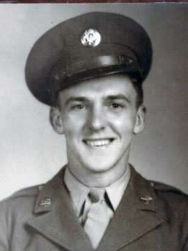 1940s era black and white headshot of young man smiling in a military uniform