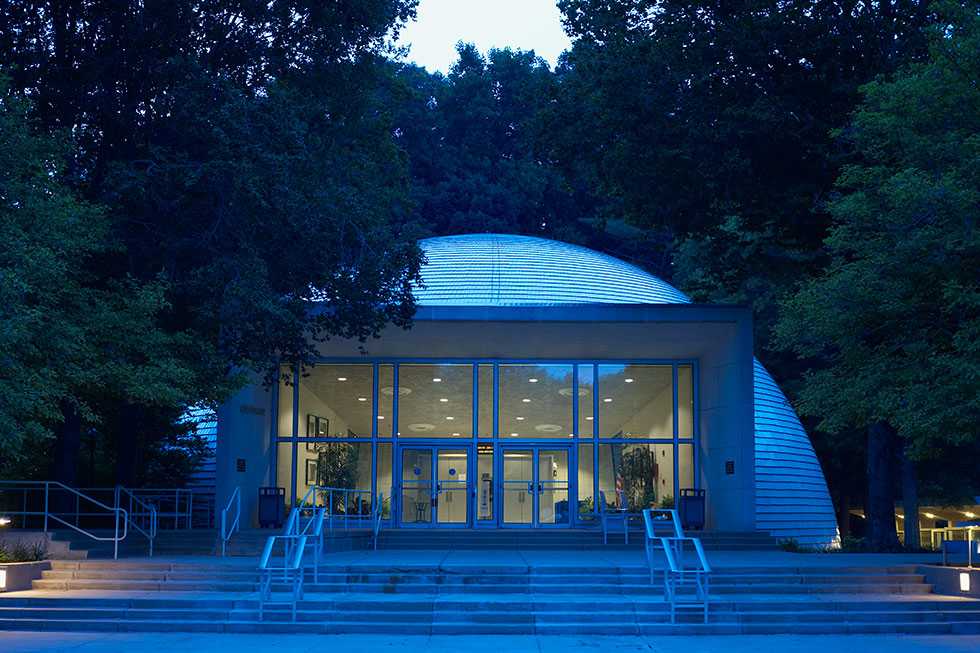 The CIA Headquarters Auditorium, an igloo shaped building surrounded by trees.