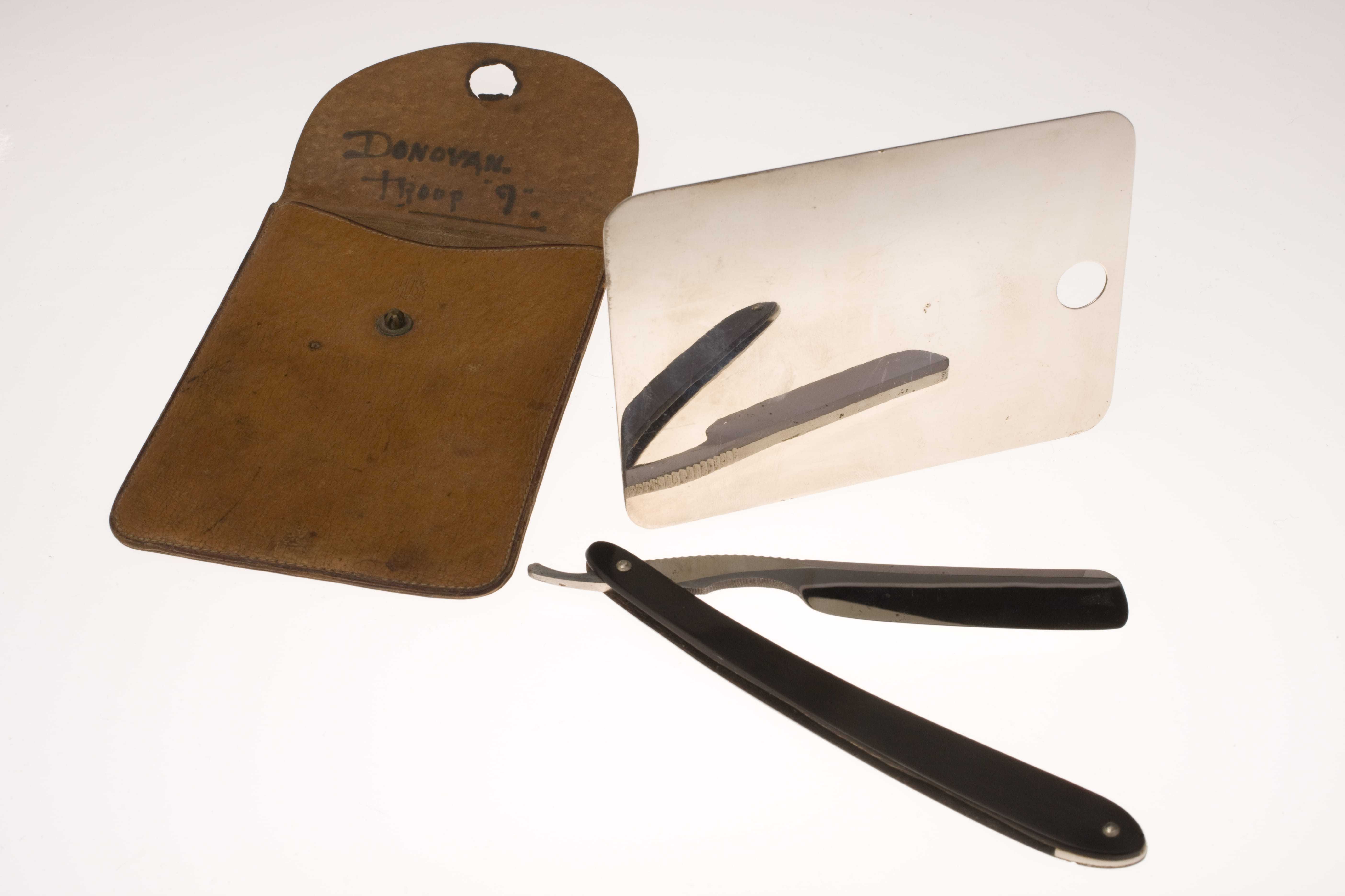 A small rectangular mirror and matching leather brown case