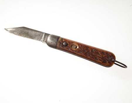 The knife fully extended to a parallel position with the handle.