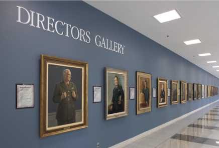 A wall at the CIA museum featuring a portrait gallery of former CIA directors.