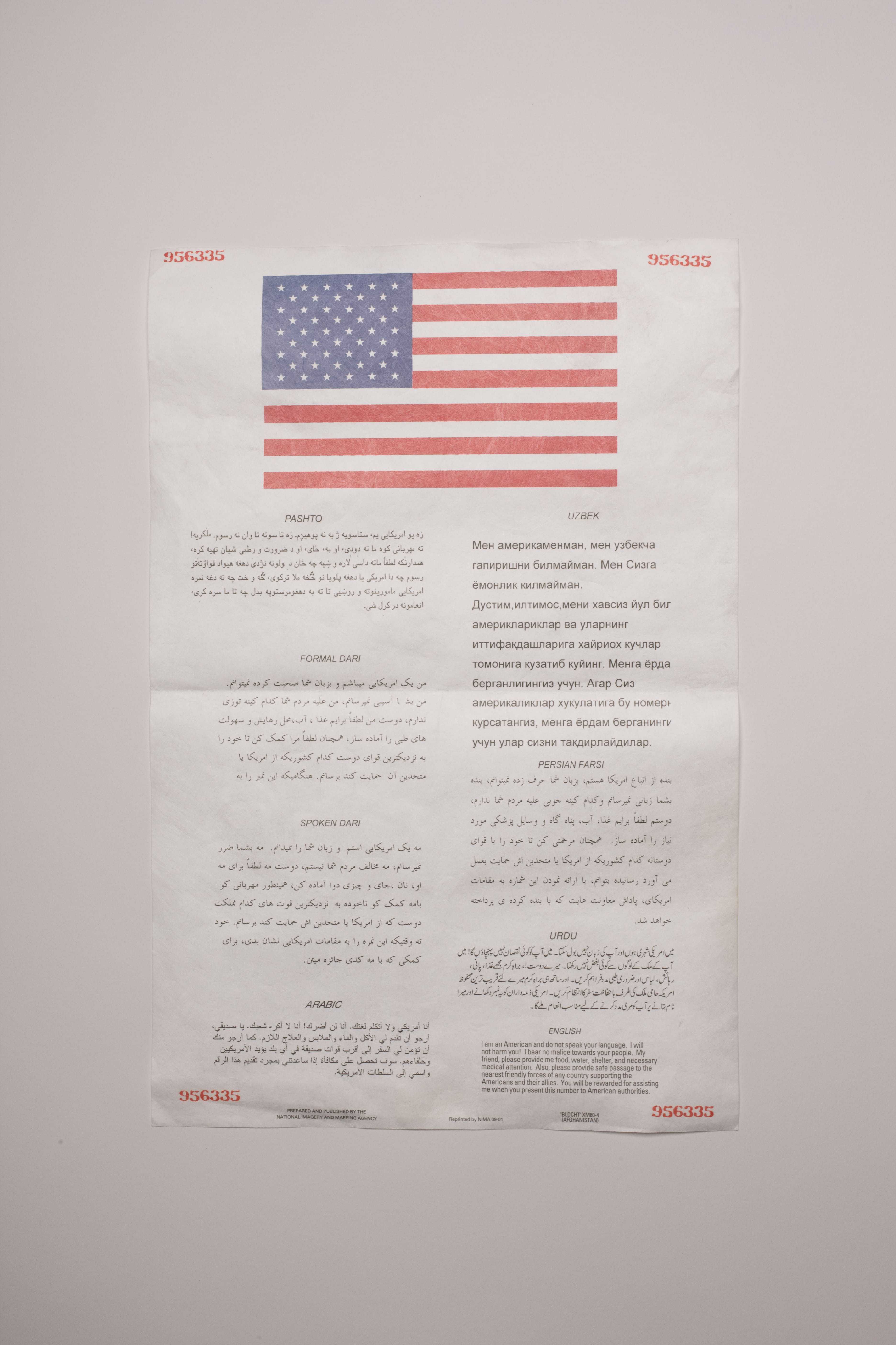 A piece of paper, with an American flag across the top and the same message in multiple languages beneath