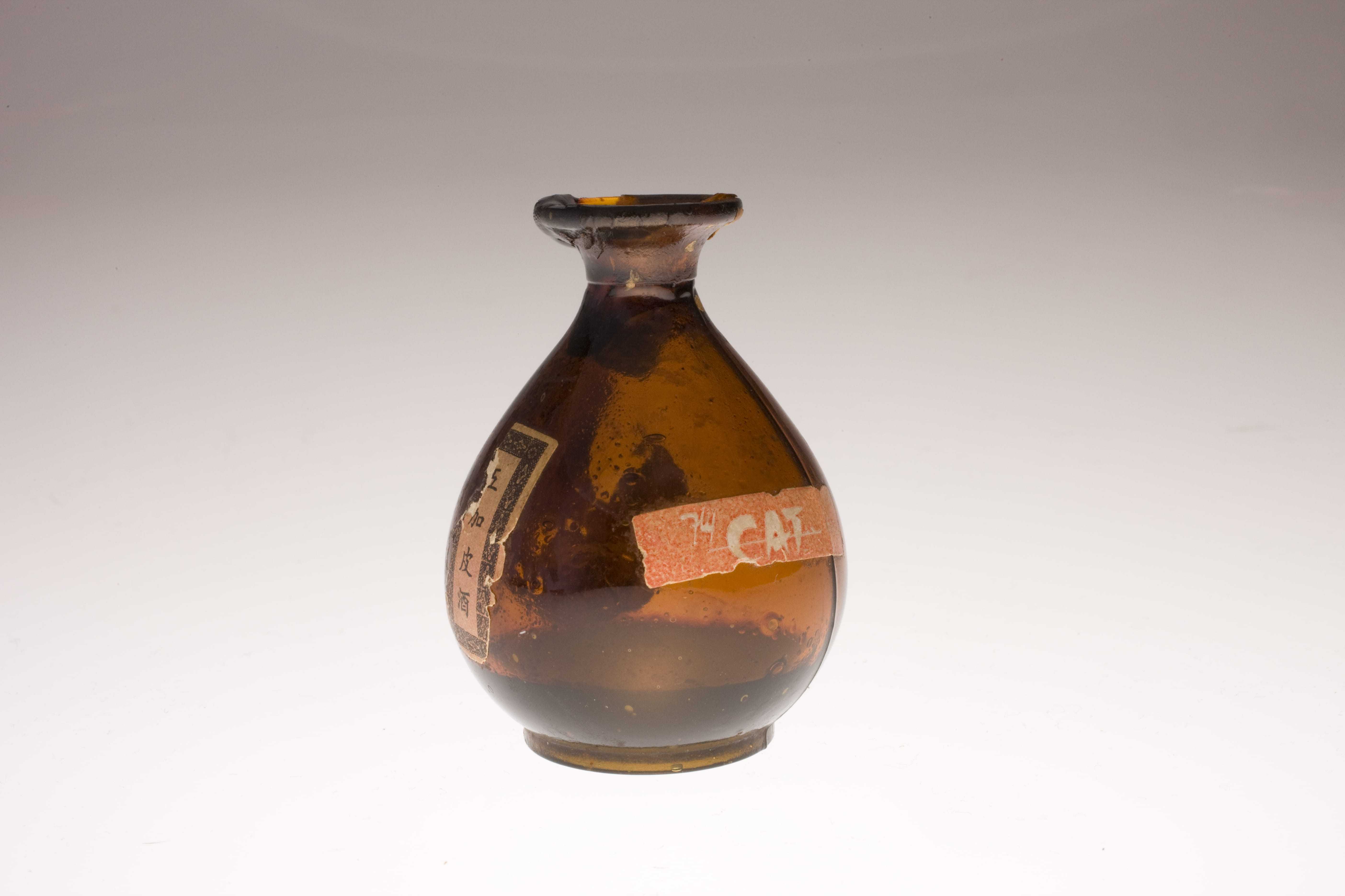 A brown translucent bottle with the Civil Air Transport label on it