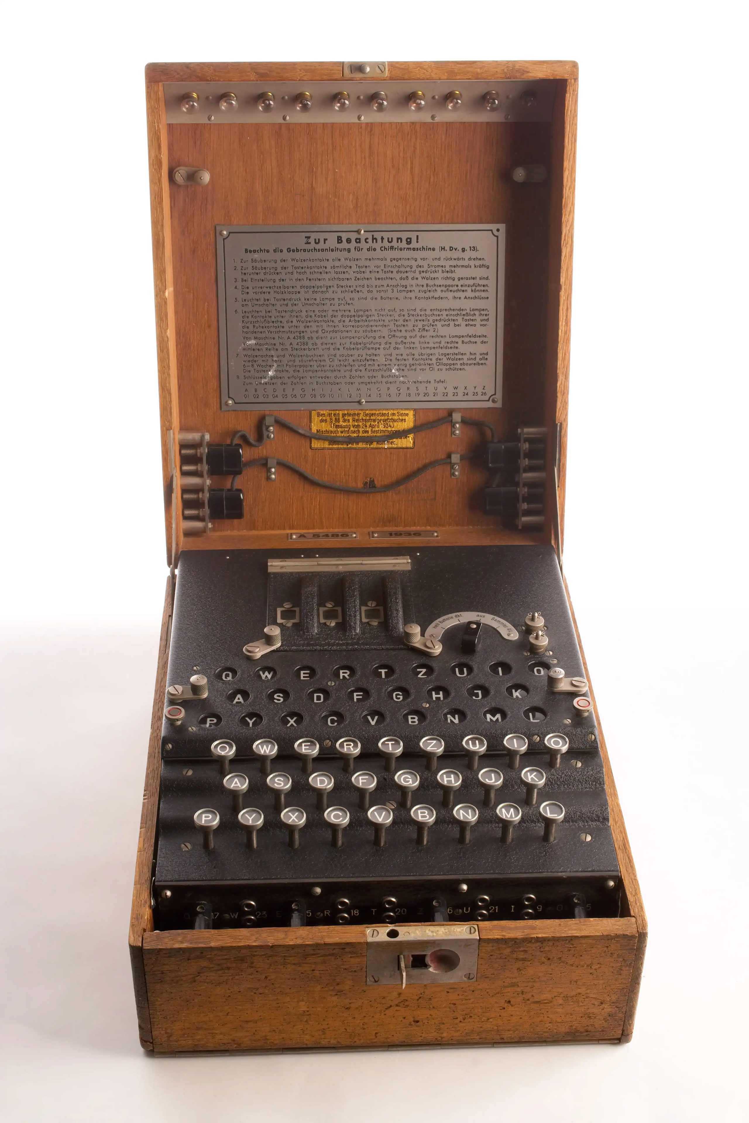 The Enigma machine, a typewriter-like object in a wooden box