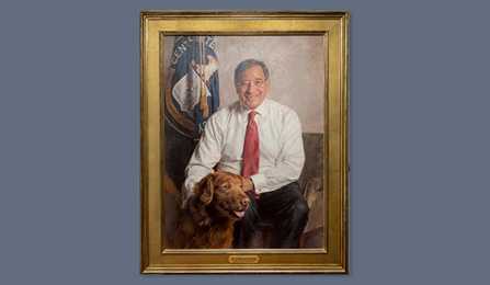 A portrait of former CIA director Leon E. Panetta in a gold frame.