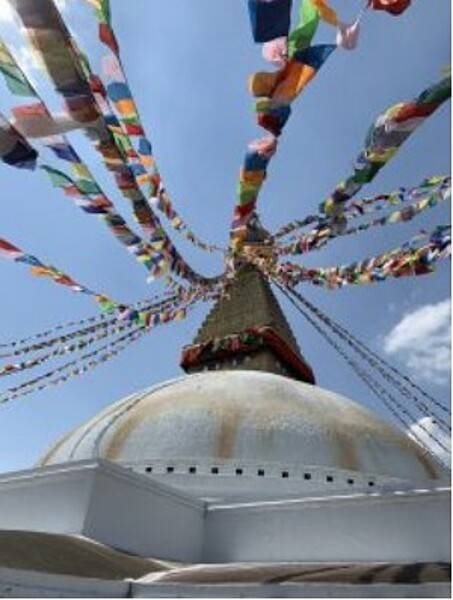 Boudha is a stupa (dome shaped Buddhist shrine) in Kathmandu. Its massive mandala symbolizes the Buddhist cosmos. Four of the Dhyani Buddhas mark the cardinal points, with the fifth, Vairocana, enshrined in the center. The five Buddhas also personify the five elements (earth, water, fire, air, and ether), which are represented in the stupa's architecture. The Boudha Stupa is a UNESCO World Heritage Site.