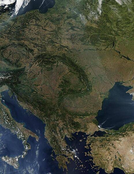 A virtually cloud-free view of Central Europe vividly displays the fishhook-shaped Carpathian Mountains that snake through the middle of the continent. Encompassed in this satellite view are all of Poland, the Czech Republic, Slovakia, Hungary, Romania, Slovenia, Greece, and all of the Balkan countries. Large parts of Lithuania, Belarus, Ukraine, Turkey, and Italy are also visible. Scattered fires are visible as red dots. Image courtesy of NASA.