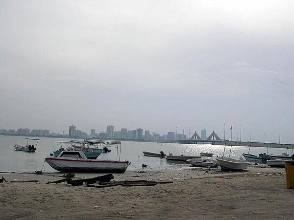 Manama, the capital of Bahrain, seen from a distance. Its wealth is based on financial services, petroleum, ship repair, and tourism; one of its shopping malls, the Seef (Souk), has luxury apartments and five-star hotels.