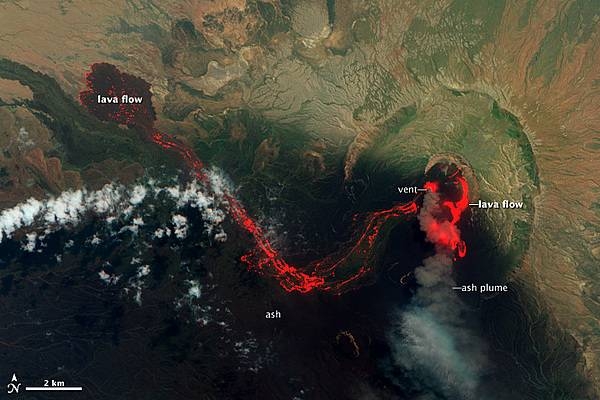 View of the Nabro Volcano as of 29 June 2011 shows the extent of the lava flow and that the intensity of the eruption has abated somewhat. The eruption continued for many more weeks. Image courtesy of NASA.