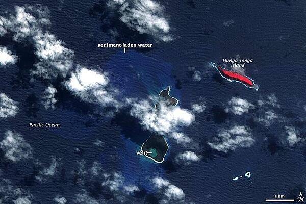 In mid-March 2009, a plume of ash and gas burst out of the ocean as an undersea volcano began to erupt in the South Pacific nation of Tonga. Small sections of the rim of the large volcano had been above water, forming the islands of Hunga Tonga and Hunga Ha&apos;apai (center). The eruption occurred at two vents, one submerged and the other on Hunga Ha&apos;apai. The eruption pumped out enough rock and ash that by 25 March, when NASA&apos;s Terra satellite captured this image, the submerged vent was surrounded by new land.

The new land is the dark mass south of Hunga Ha&apos;apai. It was not present in an earlier image taken on 14 November 2006 (next photo). In this image, clouds cover the space between the new land and Hunga Ha&apos;apai, but the new land connects Hunga Ha&apos;apai with the underwater vent, essentially enlarging the small island. The vent itself is the nearly perfectly circular hole near the southern edge of the new land.

Also revealed are some of the other impacts of the eruption. The ocean around the erupting volcano is bright blue, likely colored with ash, rock, and other volcanic debris. The eruption killed or damaged plants on Hunga Ha&apos;apai. In this false-color image, plant cover is red. In 2006, Hunga Ha&apos;apai had supported vegetation, but after the eruption, the island was black. Either the plants were buried in ash or dead in the wake of the eruption. Photo courtesy of NASA.